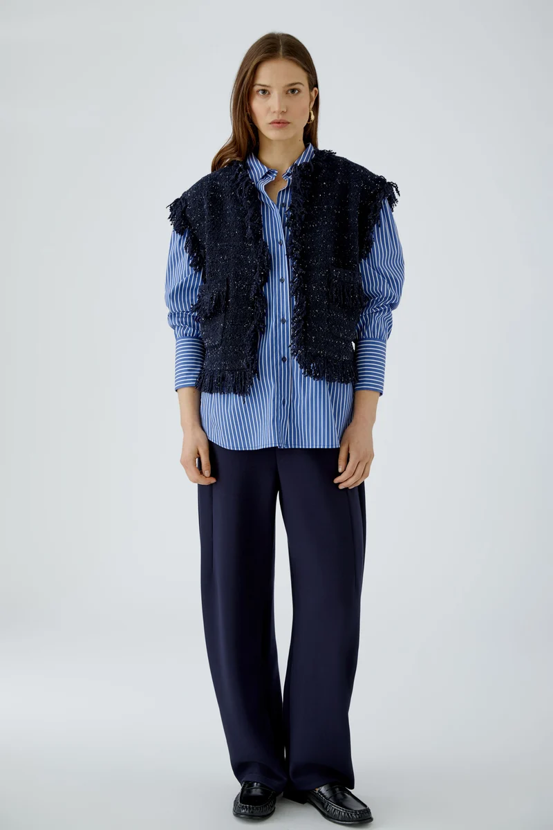 Gilet court en tweed bouclé à franges