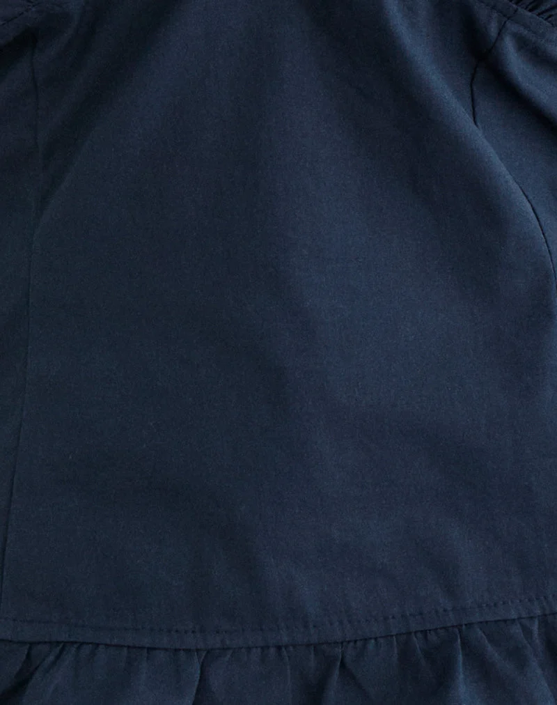 Haut à col licou Tamzen, bleu marine foncé, avec ourlet à volants
