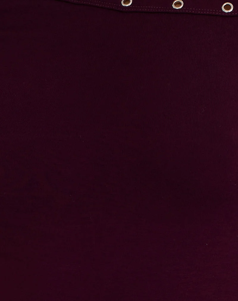 Top asymétrique Noraba en bois rouge avec œillets